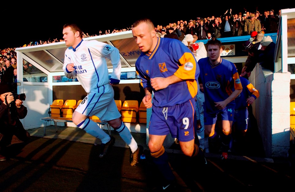 Wayne Rooney and Luke Rodgers take to the pitch ahead of Shrewsbury Town